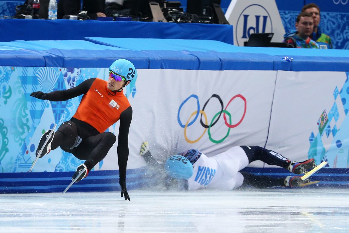 Vladimir Grigorev of Russia, right, hits the wall while Freek van der Wart of the Netherlands falls in a 500-meter short track race February 21.