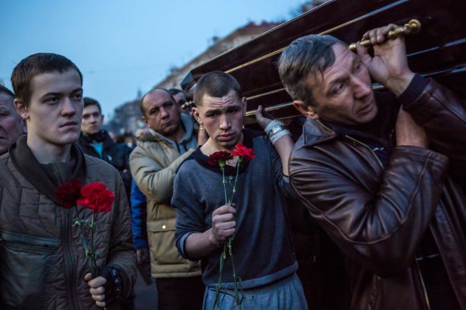 Men in Kiev carry a casket containing the body of a protester killed in clashes with police.