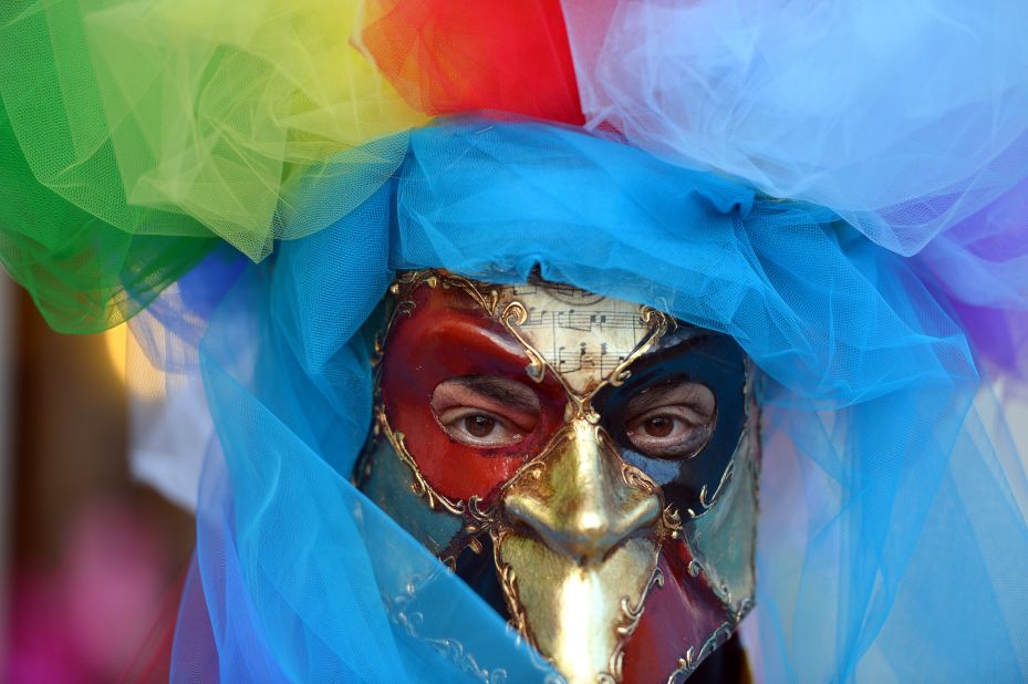 A costumed reveler poses near St. Mark's Square in Venice, Italy, during carnival celebrations on Friday, February 21. 