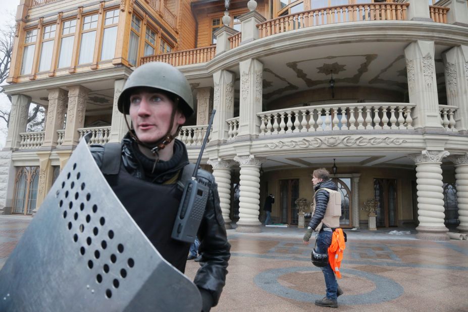 A protester guards the entrance to Yanukovych's abandoned residence outside Kiev on February 22. 