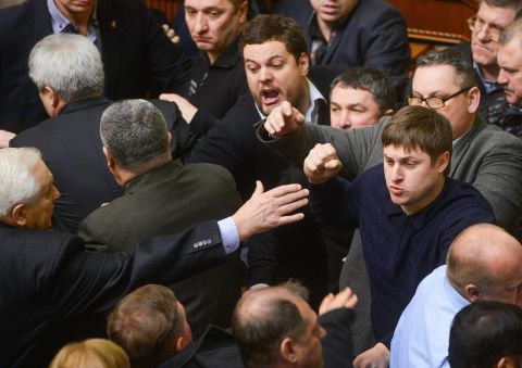 Ukrainian lawmakers argue during a session of Parliament on Friday, February 21.