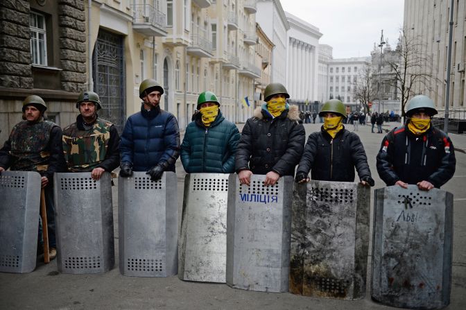 Anti-government protesters guard the streets next to the presidential offices in Kiev on February 22. 