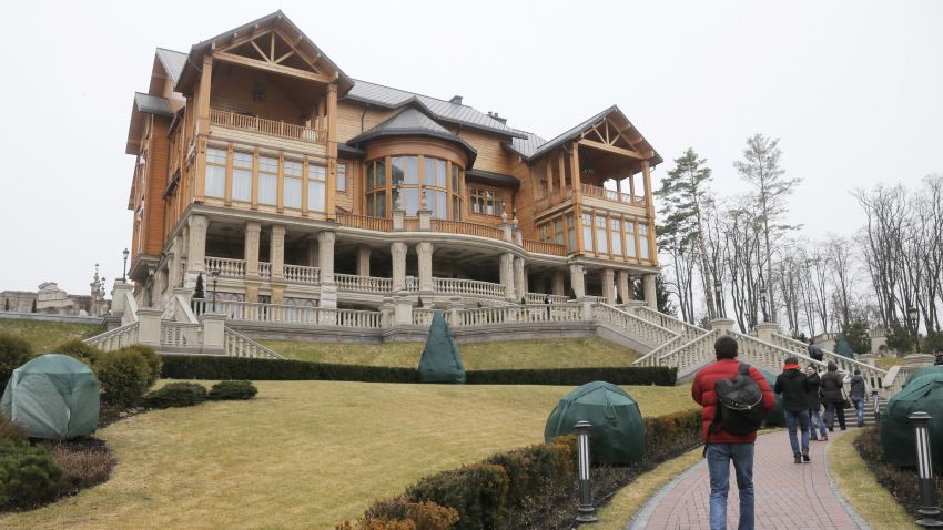 People walk around the Ukrainian presidential estate in a suburb of Kiev on Saturday, February 22, after President Viktor Yanukovych left the capital.