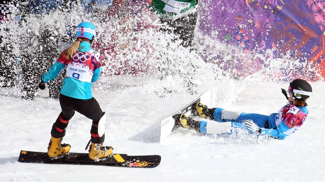 Julia Dujmovits, right, of Austria celebrates her gold medal in ladies' snowboard parallel slalom on February. She defeated Anke Karstens of Germany, left.