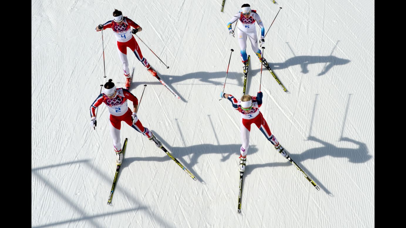 Norway's Marit Bjoergen, front left, and Norway's Therese Johaug are followed by Norway's Heidi Weng and Sweden's Charlotte Kalla on February 22 as they compete in the women's cross-country skiing 30-kilometer mass start free.