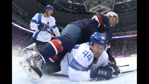 Ryan McDonagh of the United States falls on top of Kimmo Timonen of Finland on February 22 during the first period of the men's ice hockey bronze medal game.