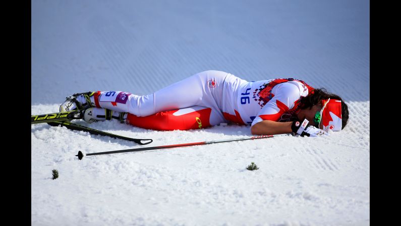 Emily Nishikawa of Canada collapses after the women's 30-kilometer mass start free cross-country event on February 22.