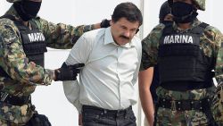 Mexican drug trafficker Joaquin Guzman Loera aka "el Chapo Guzman" (C), is escorted by marines as he is presented to the press on February 22, 2014 in Mexico City. The Sinaloa cartel leader - the most wanted by US and Mexican anti-drug agencies - was arrested early this morning by Mexican marines at a resort in Mazatlan, northern Mexico. AFP PHOTO/Alfredo Estrella        (Photo credit should read ALFREDO ESTRELLA/AFP/Getty Images)