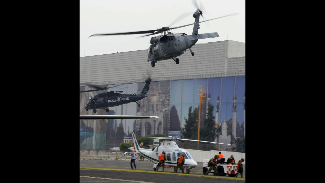Guzman was marched toward a waiting helicopter for transport to jail. 