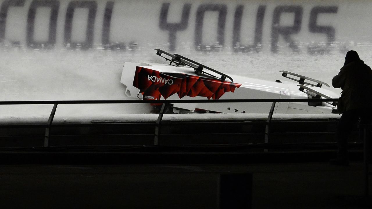 The Canadian team slides down the course upside down after the crash on February 22. 