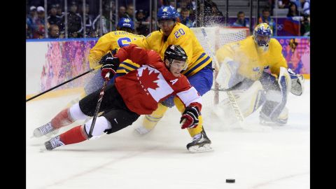 Canada's Jonathan Toews and Sweden's Alexander Steen chase the puck during the gold medal game on February 23.
