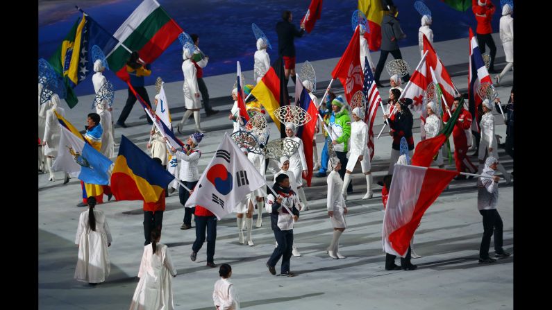 The flags of the competing nations enter the arena. 