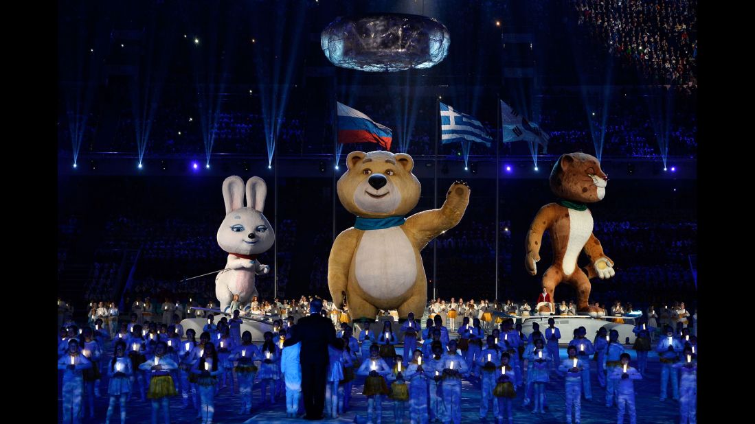 Olympic mascots the Hare, the Polar Bear and the Leopard stand by the extinguished Olympic flame. 