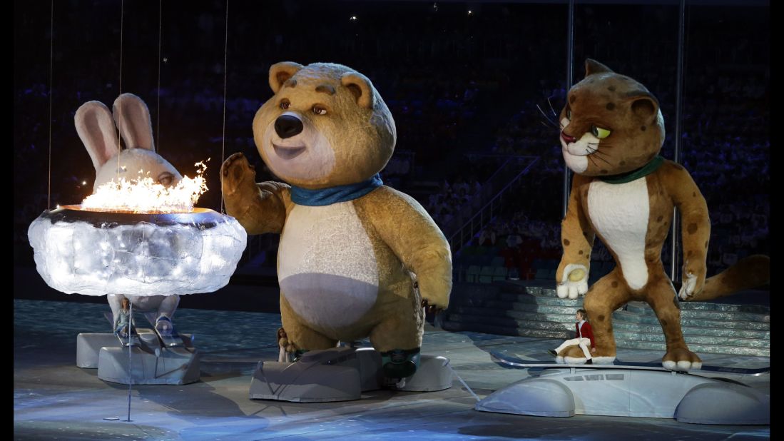 The Bear mascot blows out the Olympic flame. 