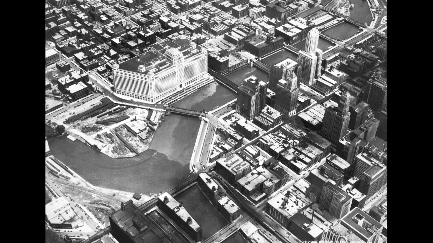 An aerial view of Chicago, circa 1930. The large white building on the Chicago River is the Merchandise Mart, with 4 million square feet of floor space spanning two city blocks and rising 25 stories. It was the largest commercial building in the world when it opened in 1930. 