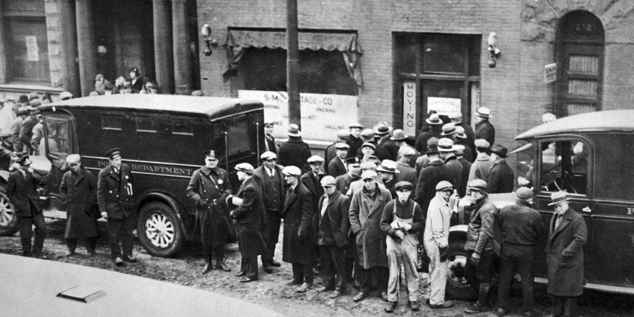 Police and spectators gather in front of the garage on Chicago's North Clark Street, where members of Al Capone's gang, disguised as policemen, shot and killed seven members of a rival gang on February 14, 1929. The St. Valentine's Day Massacre became a symbol of the extreme violence of the Chicago underworld and crime boss Al Capone.