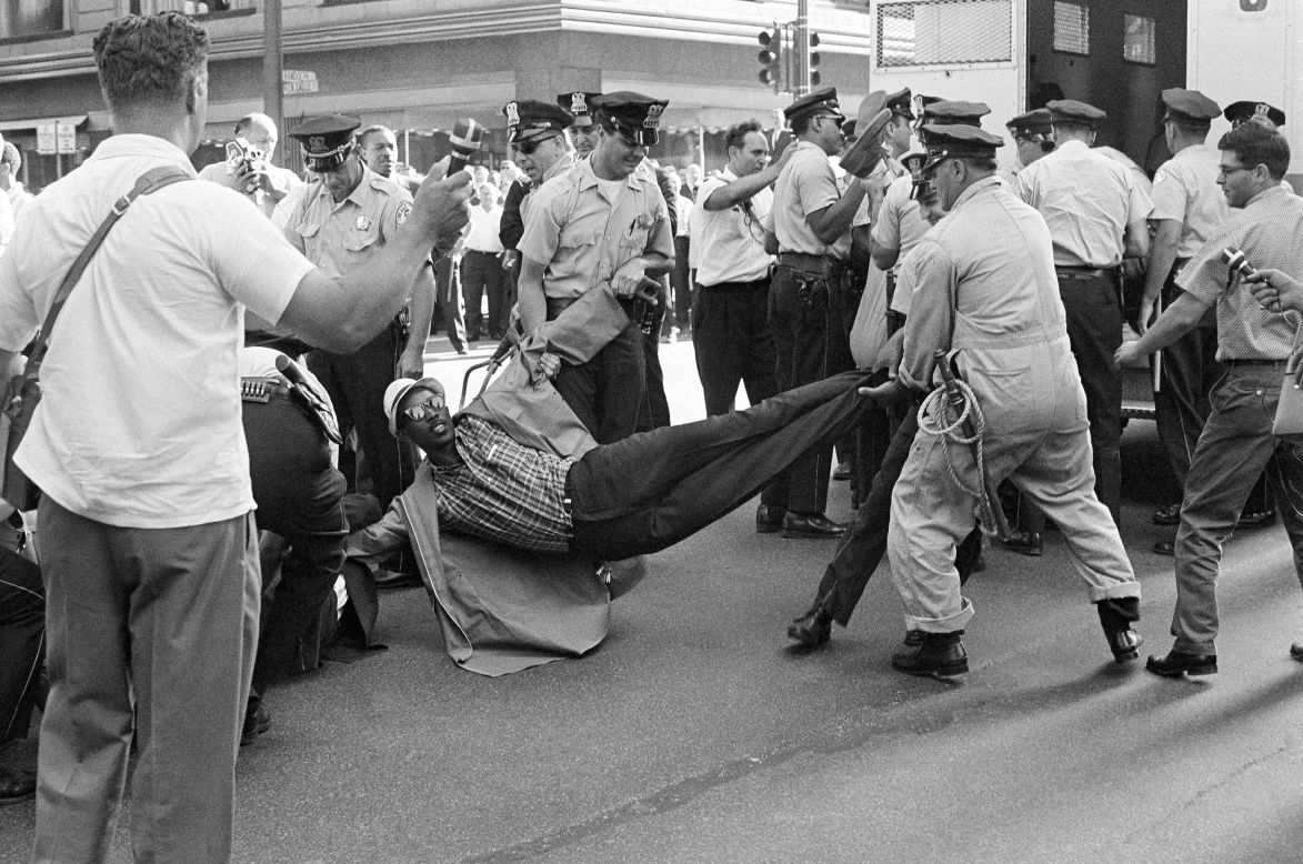 Chicago police drag away one of 80 civil-rights marchers who were arrested after staging a rush hour sit-in on a downtown street in Chicago on June 28, 1965. Leaders of the march, dissatisfied with results of a two-hour meeting with the mayor, ordered marchers to assume "arrest position."