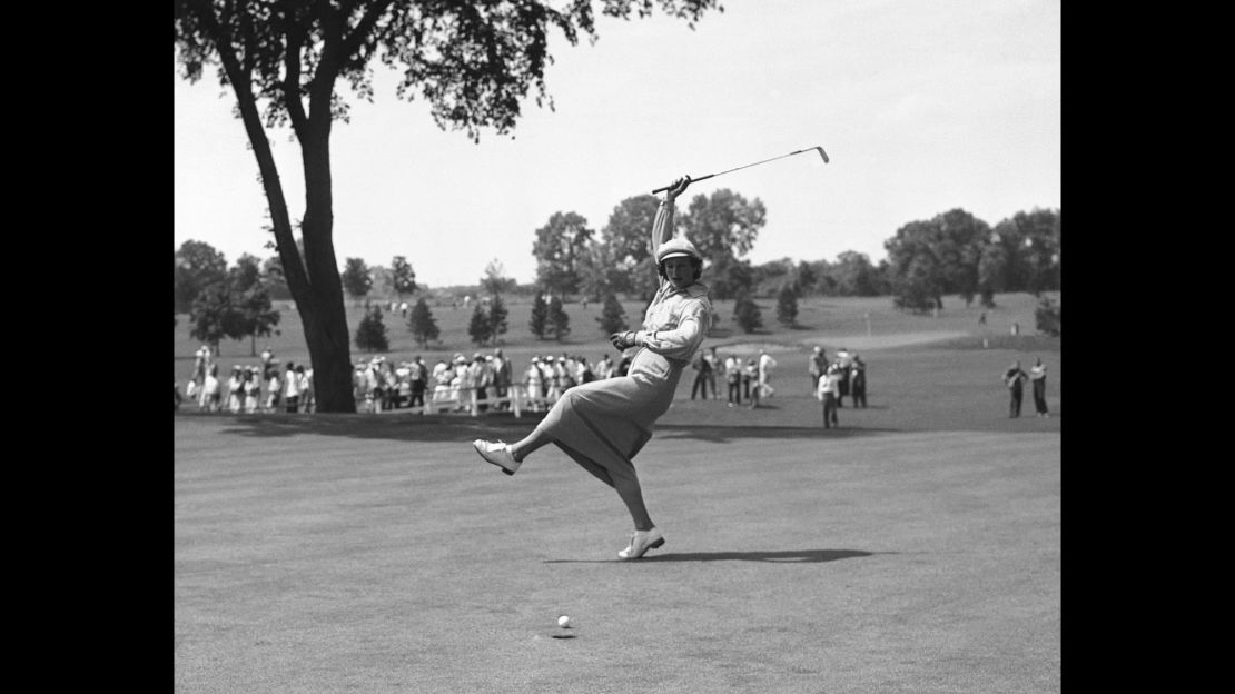 Zaharias urges the ball into the hole on the 18th green of Chicago's Tam O'Shanter Country Club in the Women's All-American Golf Tournament in 1950.