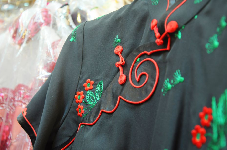 The main elements of the dress's original silhouette -- high collar, flower buttons on the placket -- make it easy to incorporate into new designs.