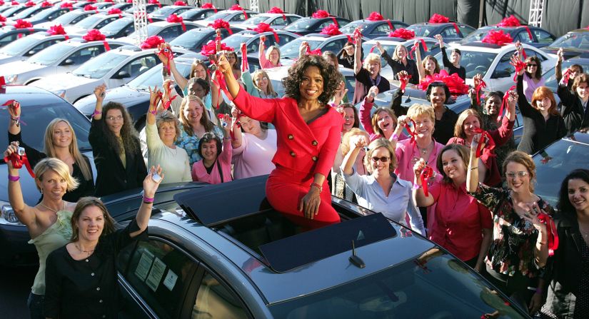 One of Chicago's most famous residents, Oprah Winfrey, sits atop a brand new car -- one of hundreds that she gave away to audience members in 2004 -- outside her Chicago studios. Winfrey moved her talk show to Chicago's West Loop in 1988, purchasing an 88,000-square-foot facility in the neighborhood, which was struggling at the time. She is now reportedly considering selling Harpo Studios, which helped revitalize the neighborhood.
