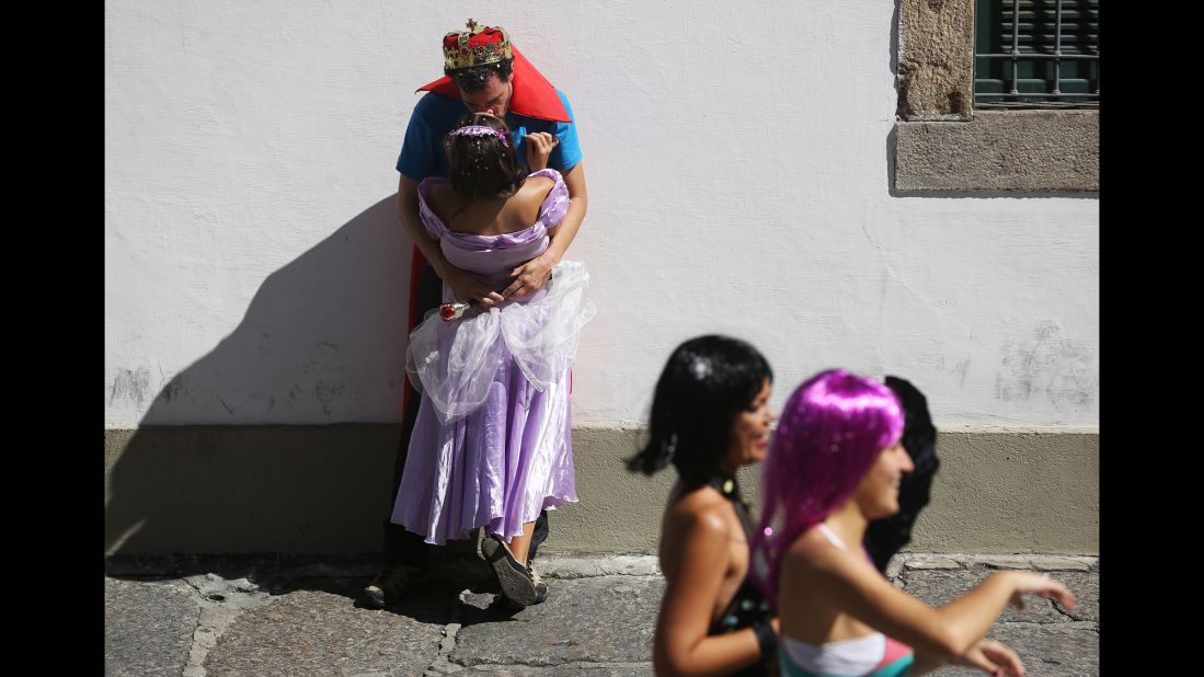 A costumed couple kisses during a pre-carnival celebration in Rio de Janeiro on Sunday, February 23. 