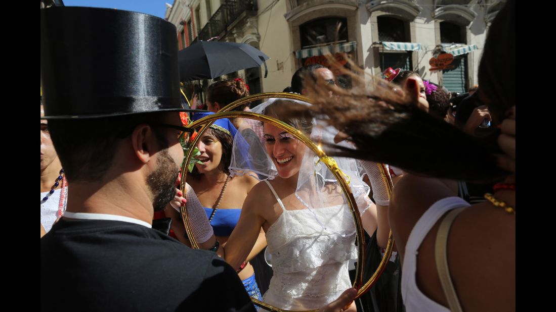 A reveler dressed as a bride holds giant wedding bands during carnival celebrations in Rio de Janeiro on February 23. 