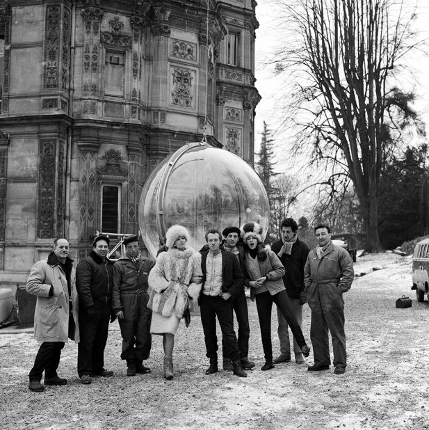 Here photographer Melvin Sokolsky, model Simone D'Aillencourt, and crew pose beside the bubble in Paris.
