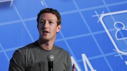 Facebook, 29-year-old billionaire founder and CEO Mark Zuckerberg (R) speaks on the opening day of the Mobile World Congress in Barcelona, on February 24, 2014.