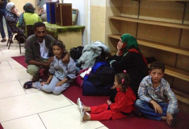 A Syrian family arrives at the mosque in Catania, Italy, on nearby Sicily.