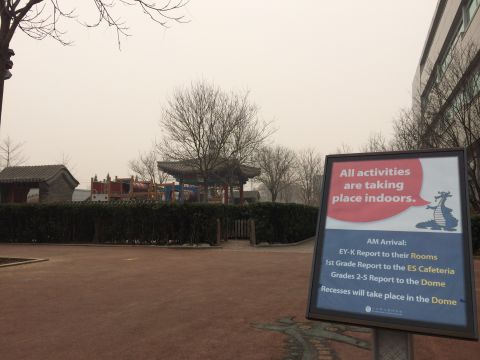 A sign points students and visitors in the direction of the dome as smog levels rise.