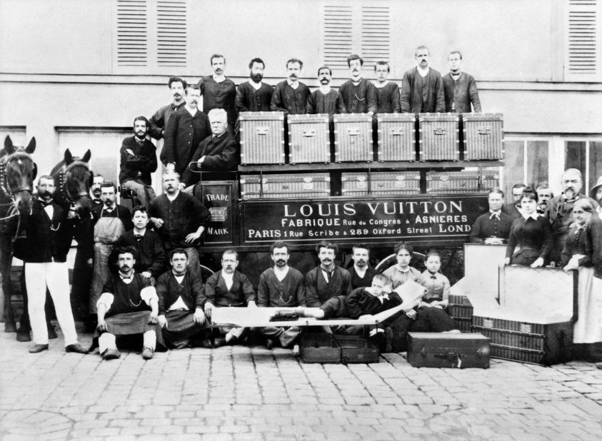 Since its founding in Paris in 1854, the Louis Vuitton company catered to the more glamorous-minded members of society, including empresses, explorers and artists. In this photo from 1888, Louis Vuitton's son Georges and grandson Gaston-Louis pose with factory workers in front of a horse-drawn delivery van.