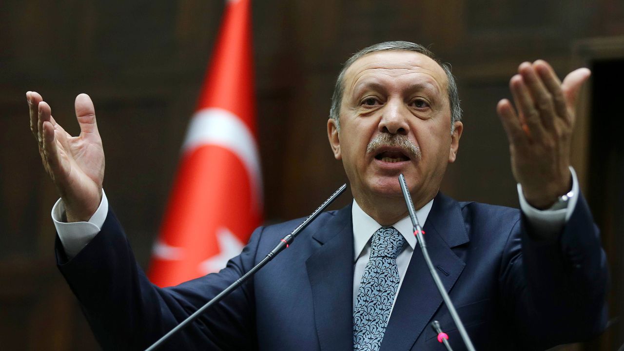 Turkey's Prime Minister Recep Tayyip Erdogan addresses members of his ruling AK Party (AKP) during a session at the Turkish parliament in Ankara on February 25, 2014.