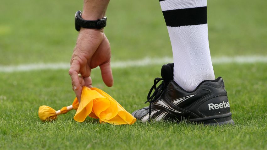 A penalty flag is picked up by an NFL referee.