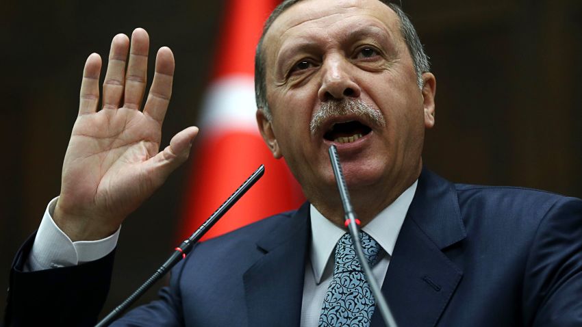 Turkey's Prime Minister Recep Tayyip Erdogan addresses members of his ruling AK Party (AKP) during a session at the Turkish parliament in Ankara on February 25, 2014.