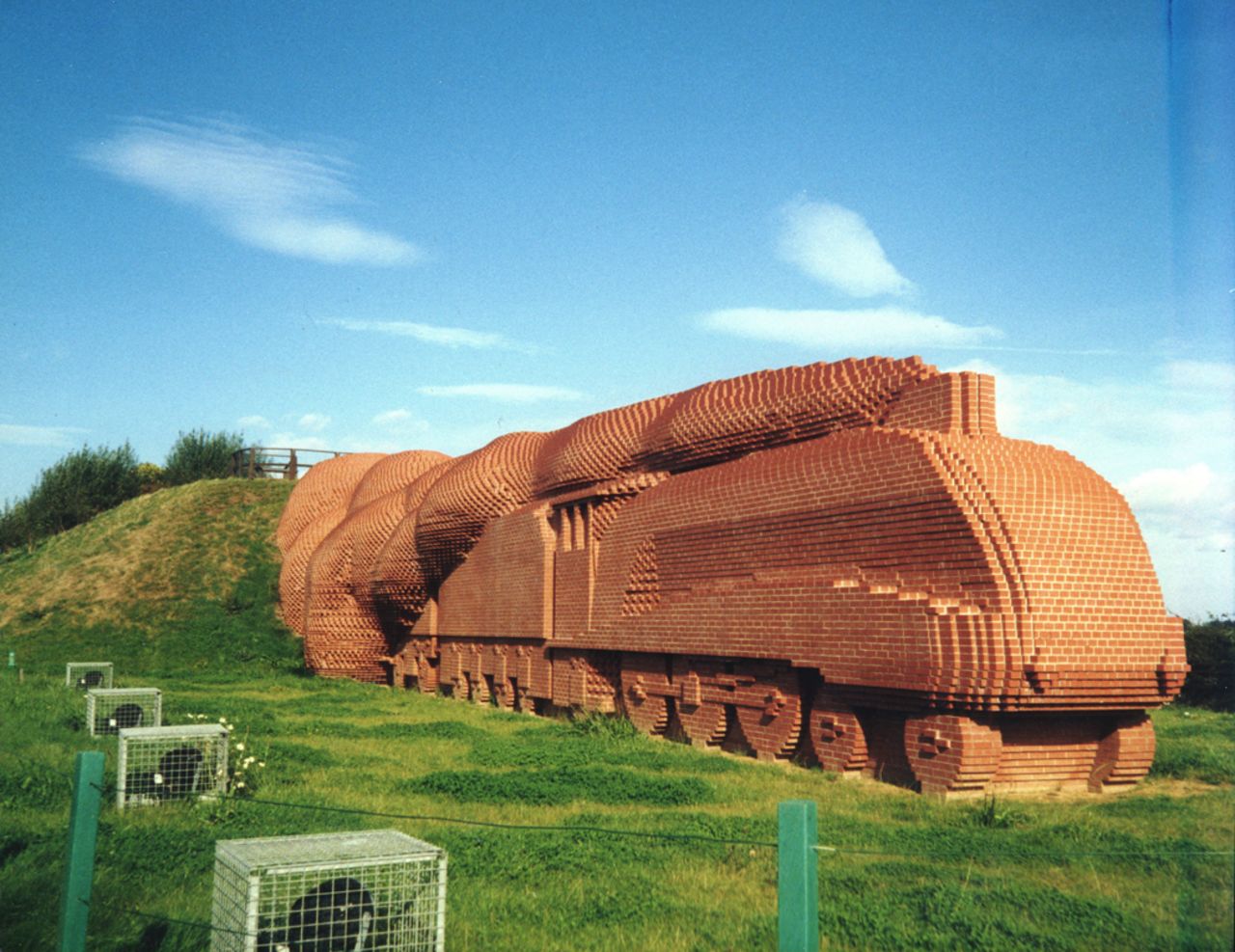 In 1997 he made a train out of 185,000 bricks, weighing 15,000 tons, coming out of a hillside near the northern English town of Darlington.