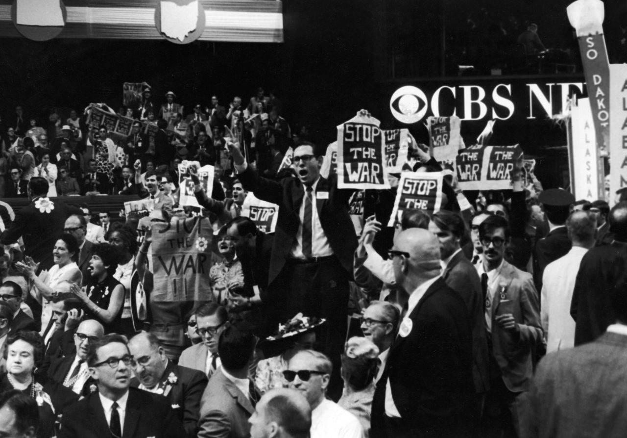 Members of the New York delegation protest against the Vietnam War during the 1968 Democratic National Convention held in Chicago. Outside, riots erupted, with tens of thousands of Vietnam War protesters clashing with Chicago police and National Guard forces.