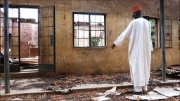 A staff inspects on August 6, 2013 a burnt student hostel in the Government Secondary School of Mamudo in northeast Nigerian Yobe state where Boko Haram gunmen launched gun and explosives attacks on student hostels on July 6, 2013, killing 41 students and a teacher, the group's dealiest in its wave of attacks on schools as part of its armed campaign to establish an Islamic state in the West African nation. Gunfire and explosions shook one northeastern Nigerian town on August 6, 2013 while soldiers slapped a round-the-clock curfew on another in the region hit by waves of insurgent attacks, the military and residents said. Clashes broke out in the town of Gamboru Ngala on the border with Cameroon on Monday night and continued on Tuesday, a resident said. The military had not commented on the situation there and details remained unclear. AFP PHOTO / AMINU ABUBAKAR (Photo credit should read AMINU ABUBAKAR/AFP/Getty Images)
