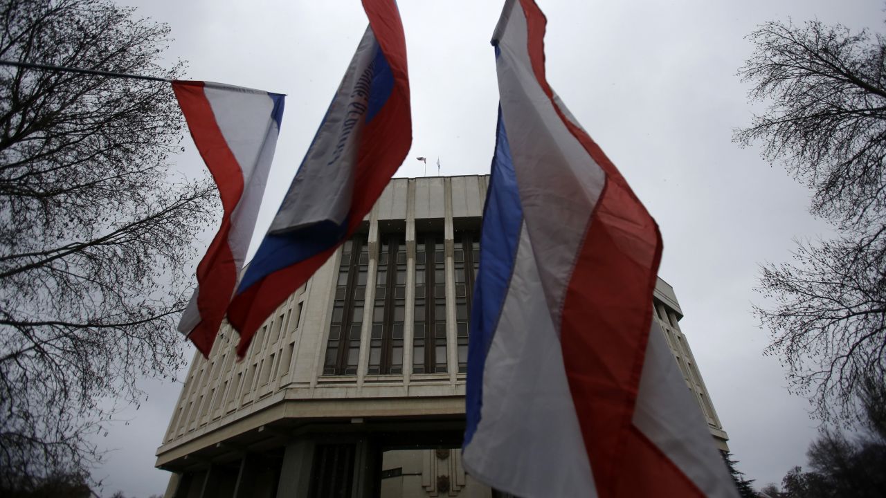 Pro-Russia demonstrators wave Russian and Crimean flags in front of a local government building in Simferopol on February 27. 