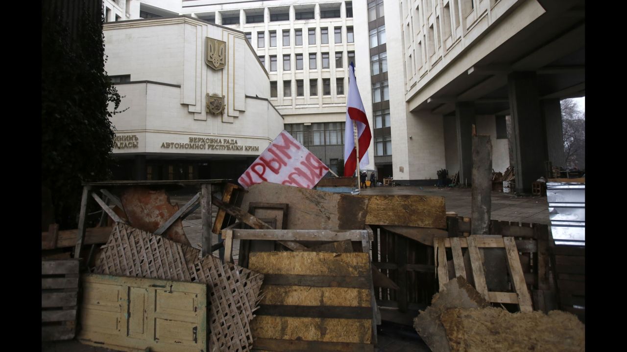 Barricades in front of a government building in Simferopol on February 27 hold a banner that reads: "Crimea Russia." There's a broad divide between those who support the pro-Western developments in Kiev and those who back Russia's continued influence in Crimea and across Ukraine.