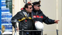 The captain of the wrecked Costa Concordia cruise ship Francesco Schettino (L) is escorted after he went onboard the wrecked Costa Concordia cruise ship in Giglio Port on February 27 , 2014.