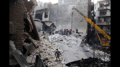 People dig through the rubble of a building in Damascus that was allegedly hit by government airstrikes on Thursday, February 27. 