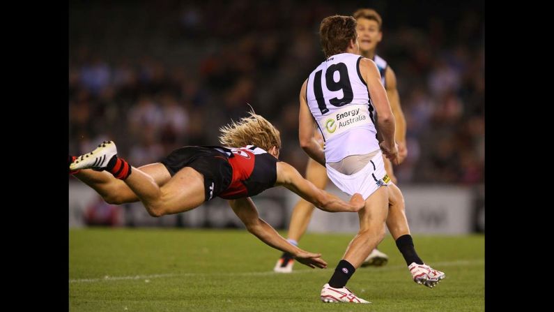 Dyson Heppell of Essendon tackles Matt White of Port Adelaide during an Australian rules football match in Melbourne on Tuesday, February 25.