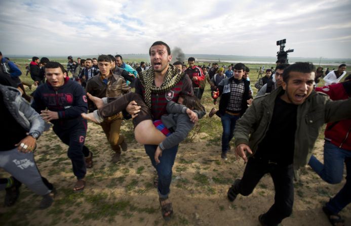 Palestinian civilians carry an injured boy during clashes with Israeli security forces near the eastern border of Gaza on Friday, February 21.