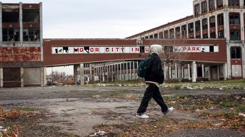 A person walks past the old Packard Motor Car Company in Detroit, which took a hit when its auto industry crumbled.