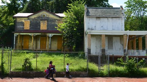 A boarded-up house sits blocks from the Anacostia Playhouse, in a Washington neighborhood undergoing gentrification.