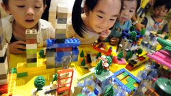 (FILES) - Japanese children look at their work made by LEGO bricks as part of the Dream City building event produced by LEGO education in Tokyo on August 16, 2009. Danish toy maker Lego on September 5, 2013 reported an 18-percent rise in first-half net profit as revenue grew 13 percent, fuelled by growth in Asia as developed markets stalled. AFP PHOTO/Kazuhiro NOGIKAZUHIRO NOGI/AFP/Getty Images