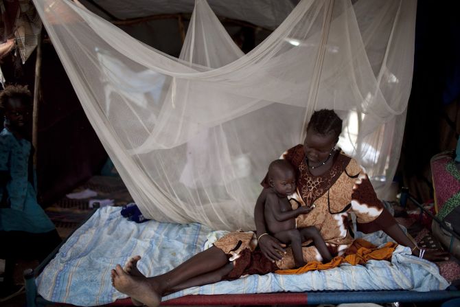 A Nuer woman rests on a bed with her son in a camp for internally displaced people in Bor, South Sudan, on Thursday, February 27. <a href="http://www.cnn.com/2014/02/01/world/africa/south-sudan-aid-workers/index.html">Violence has quickly spread</a> throughout the country since rebels loyal to ousted Vice President Riek Machar tried to stage a coup in mid-December.