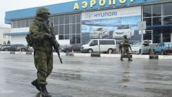 SIMFEROPOL, UKRAINE - FEBRUARY 28: Soldiers, who were wearing no identifying insignia and declined to say whether they were Russian or Ukrainian, patrol outside the Simferopol International Airport after a pro-Russian crowd had gathered on February 28, 2014 near Simferopol, Ukraine. According to media reports Russian soldiers have occupied the airport at nearby Sevastapol in a move that is raising tensions between Russia and the new Kiev government. Crimea has a majority Russian population and pro-Russian men have occupied government buildings in Simferopol. (Photo by Sean Gallup/Getty Images)
