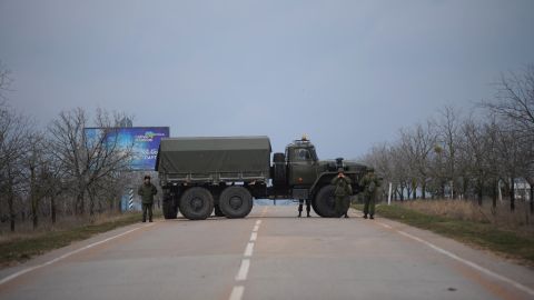 Russian troops block a road February 28 toward the military airport in Sevastopol. The Russian Black Sea Fleet is based at the port city.