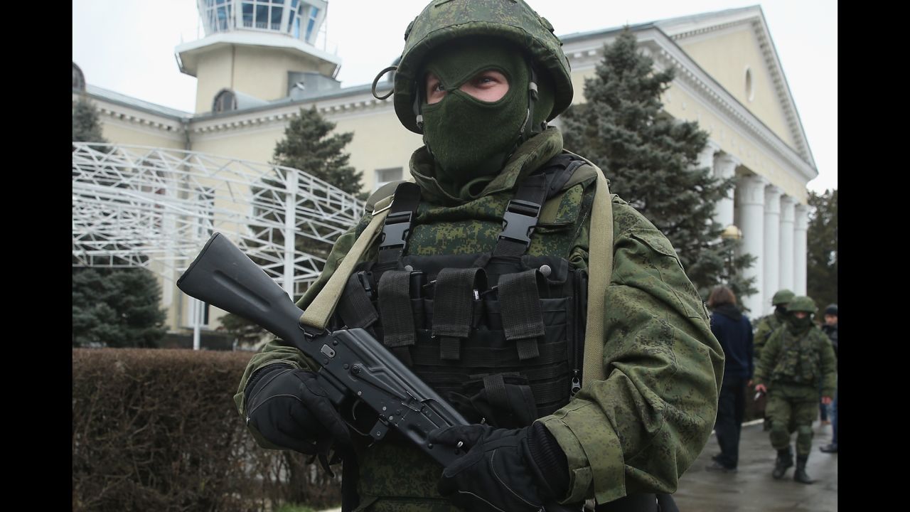 An armed man wearing no identifying insignia patrols outside Simferopol International Airport on February 28. 